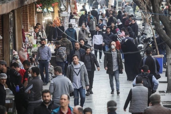 Crowds navigate a busy street in Iran