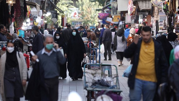 Iranians walk down a market street in Tehran, Iran November 14, 2021.