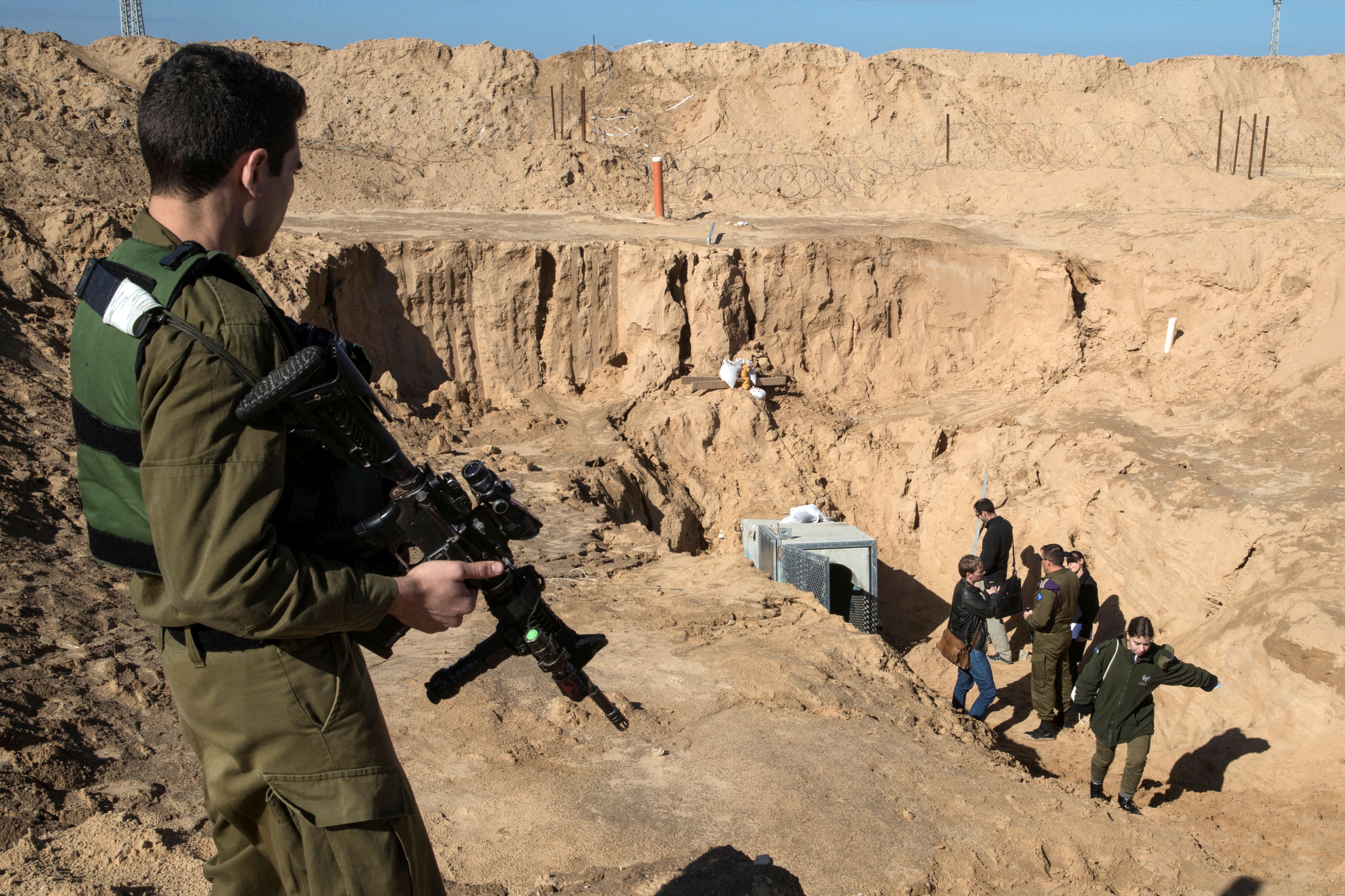 An Israeli soldier keeps guard next to an entrance to what the Israeli military say is a cross-border attack tunnel dug from Gaza to Israel, on the Israeli side of the Gaza Strip border near Kissufim January 18, 2018. 