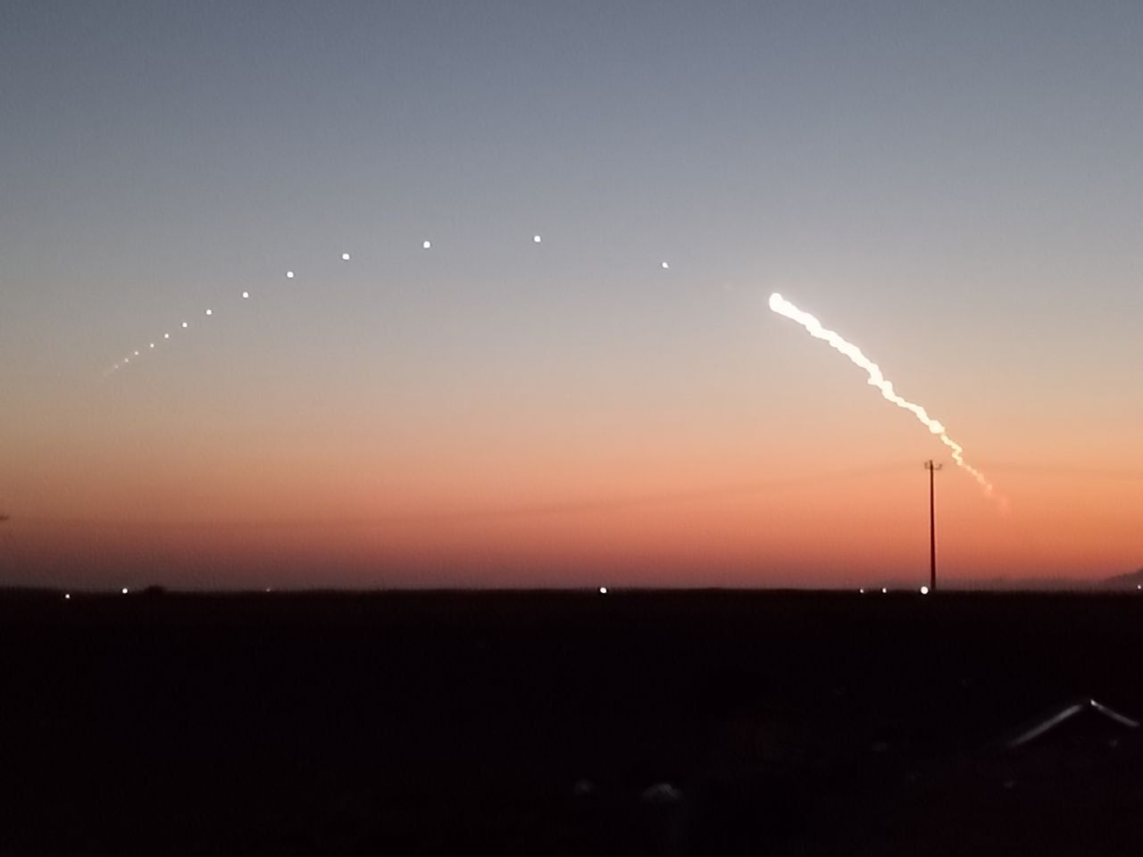 Rare missile tests streak through Tehran twilight