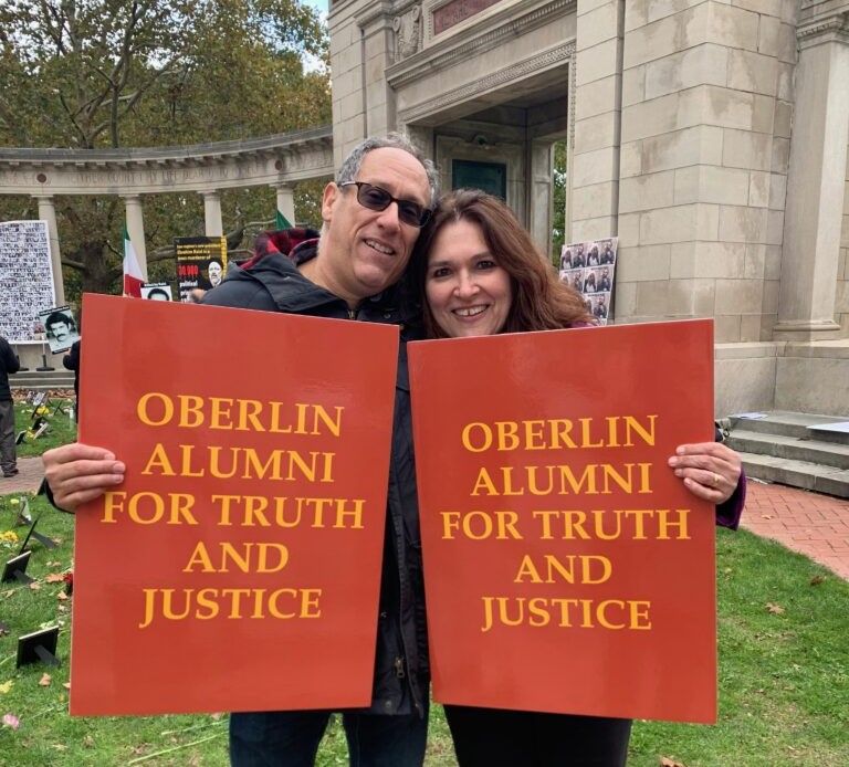 Two protesters at the gates of Oberlin college in November 2021. Photo by Melissa Landa