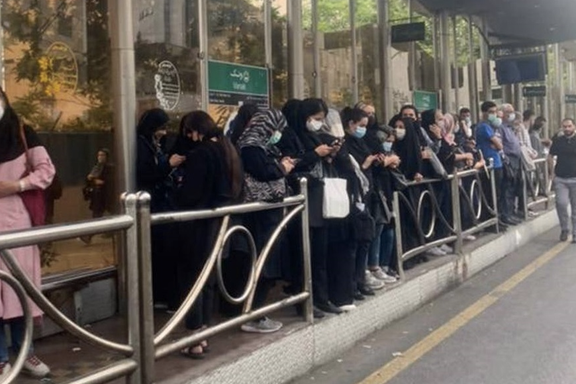 People waiting for transportation as city buse drivers in Tehran continue their strike