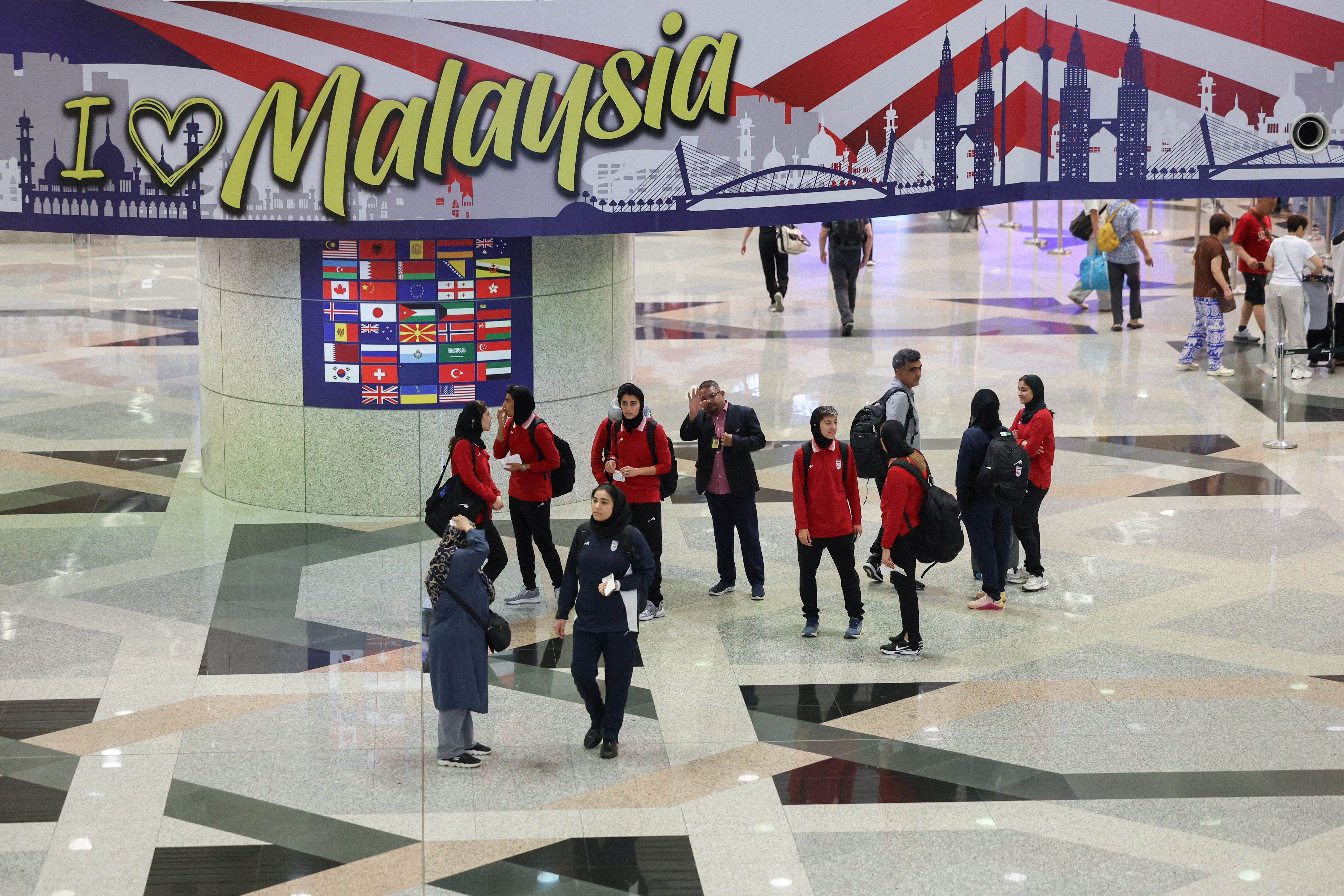 Members of the Iranian women's national soccer team stand at Kuala Lumpur International Airport as they prepare to leave Malaysia on March 16, 2026. 