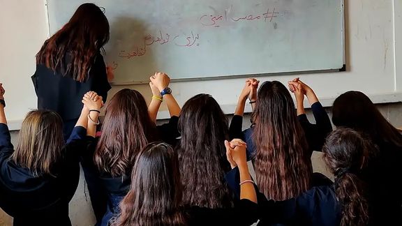 Students taking off their mandatory head-covers during Iran's 2022 Woman Life Freedom movement