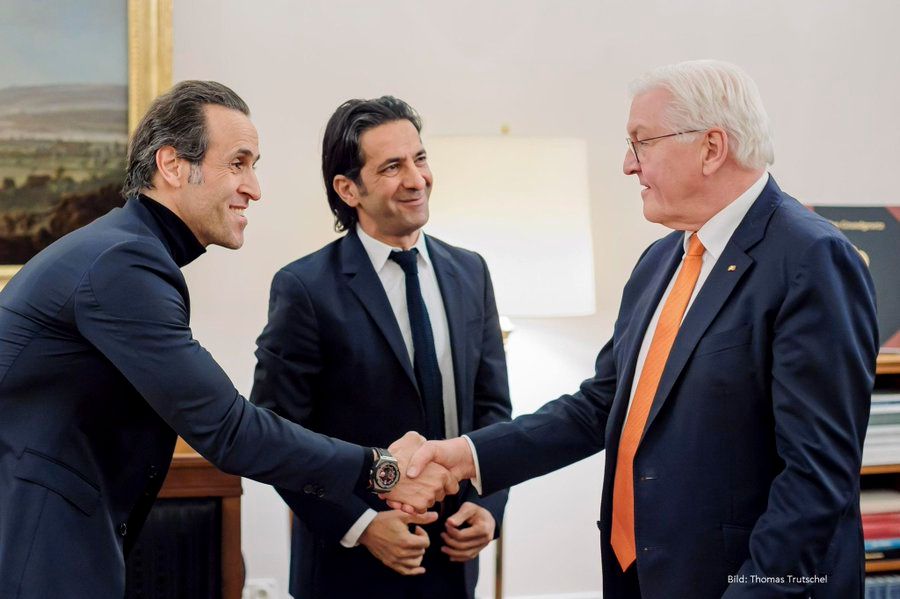 Iranian football star Ali Karimi with German President Frank-Walter Steinmeier on December 21, 2022