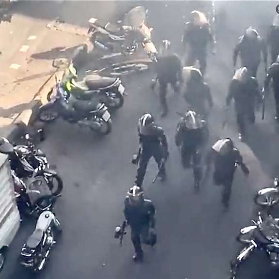 Anti-riot forces attacking protesters in Tehran, on October 12, 2022