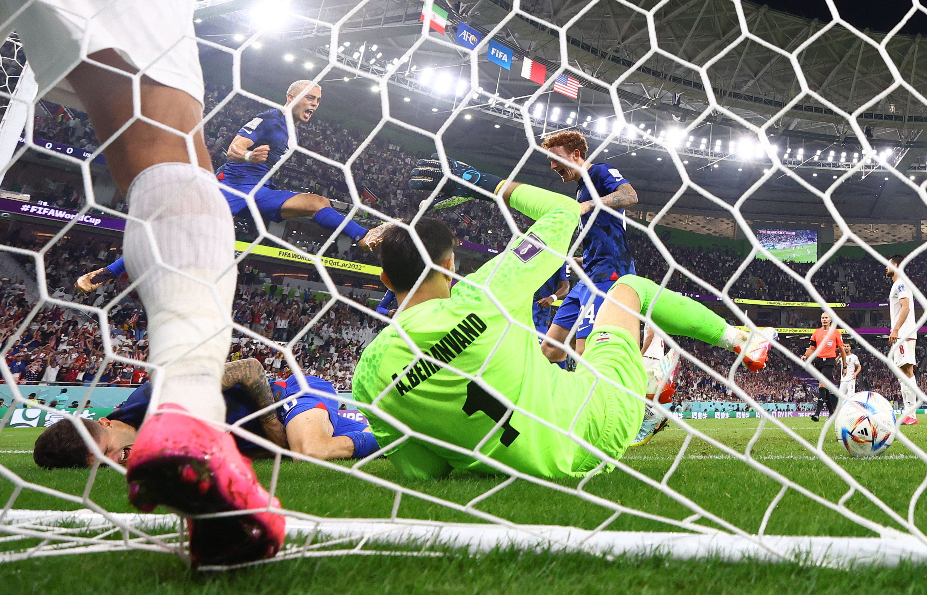Christian Pulisic of the US after he scores their first goal and collides with Iran's goalie Alireza Beiranvand  (November 29)