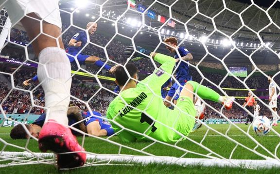 Christian Pulisic of the US after he scores their first goal and collides with Iran's goalie Alireza Beiranvand (November 29)