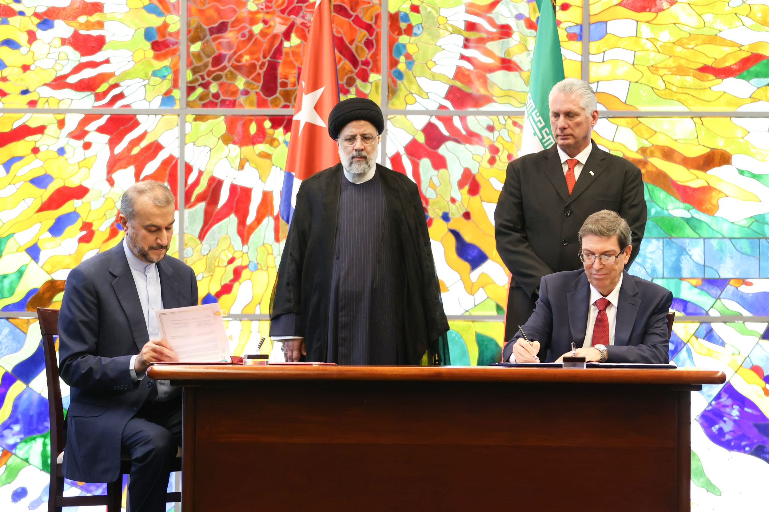 Iranian President Ebrahim Raisi and his Cuban counterpart Miguel Diaz-Canel look as foreign ministers of the two countries sign agreements during a meeting at the Palace of the Revolution in Havana on June 15, 2023 