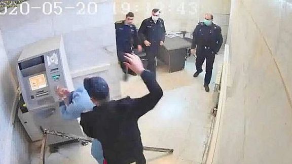 Hackers released this photo from Evin prison in 2021 showing guards assaulting a prisoner.