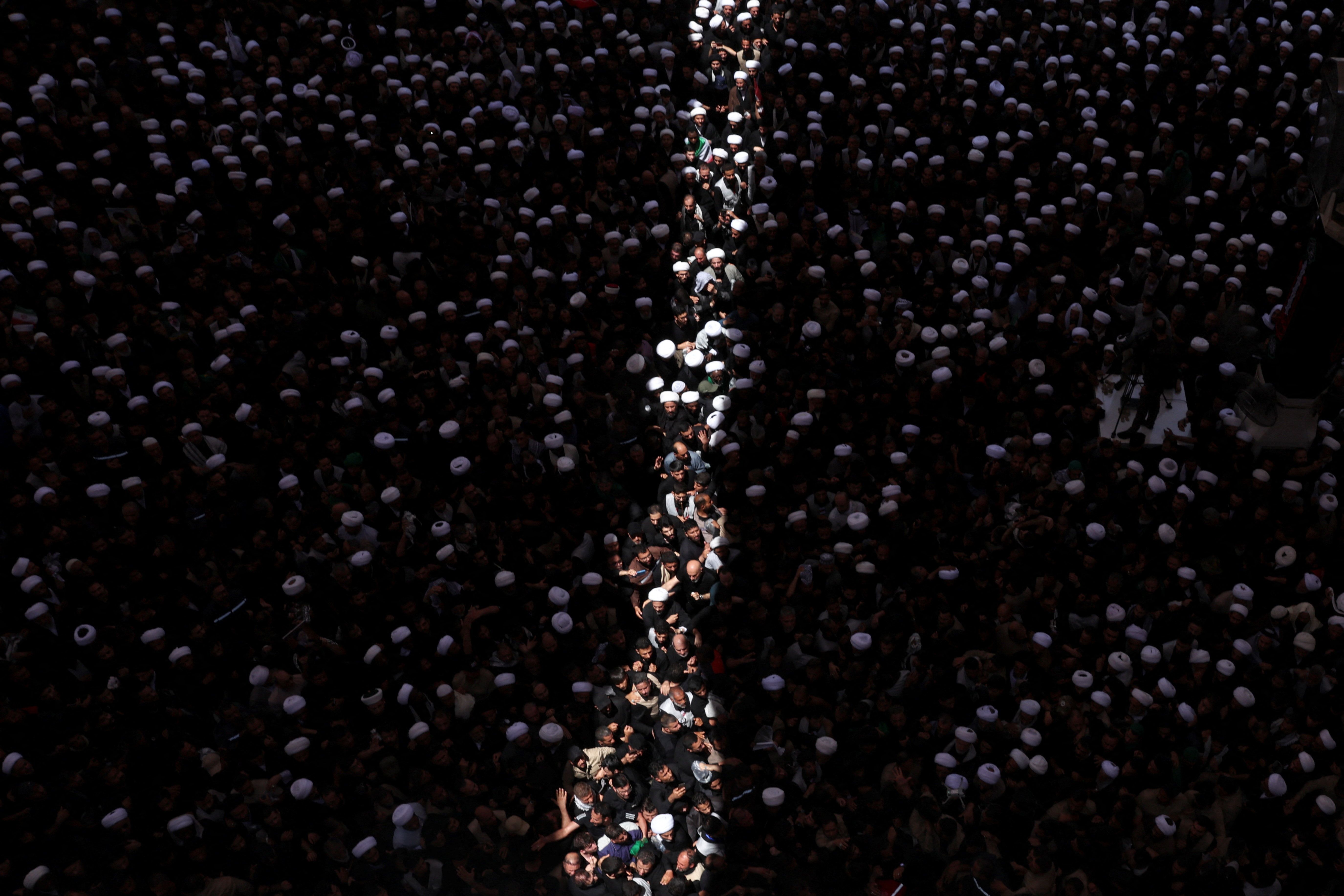 People attend a funeral procession for Iran's late Supreme Leader Ali Khamenei at the Imam Ali Shrine in Najaf, Iraq, July 8, 2026. 