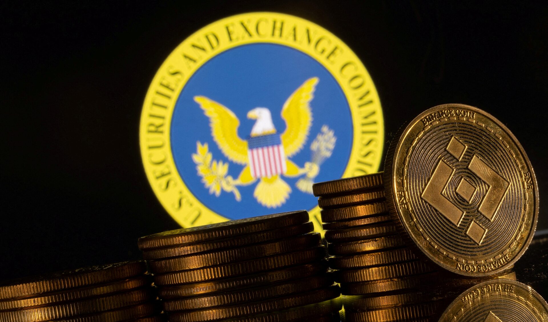 US Securities and Exchange Commission logo and representations of cryptocurrency Binance are seen in this illustration taken June 6, 2023. 