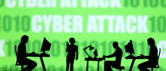 Miniatures of people with computers are seen in front of binary codes and words 'Cyber attack' in this illustration taken July 19, 2023.