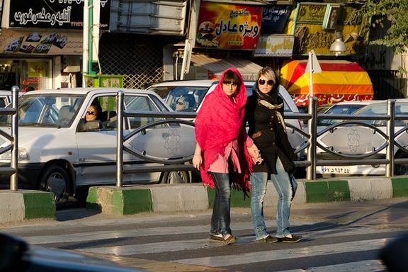 Pedestrians and drivers in a Tehran street.