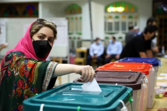 An Iranian woman casts her vote during the presidential election at a polling station in Tehran, Iran June 18, 2021.