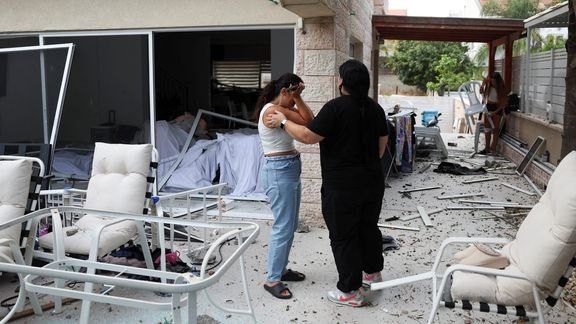 A woman reacts as she stands inside a damaged house at an impact site following missile attack from Iran on Israel, in Rishon LeZion, Israel, June 14, 2025.