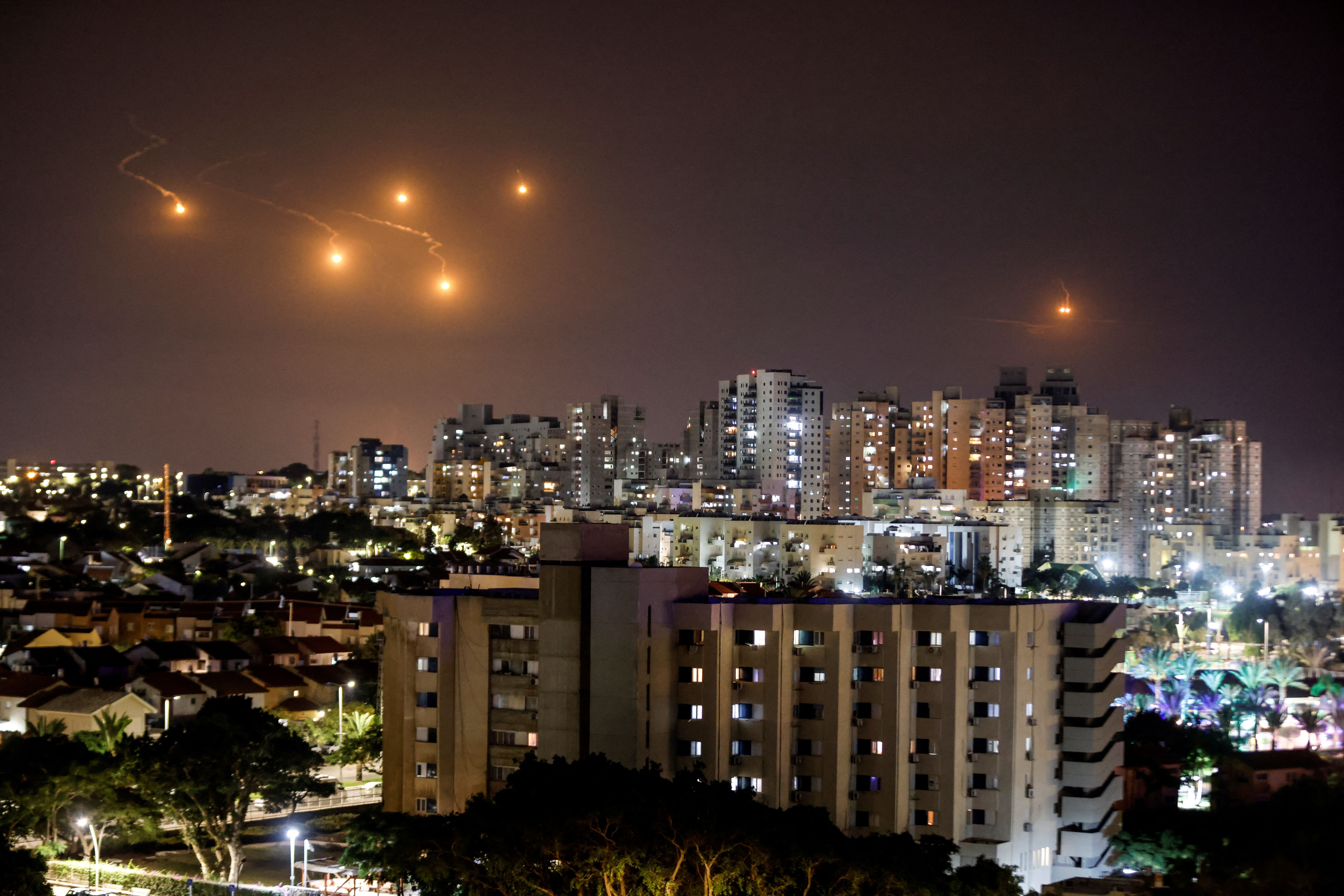 Flares illuminate the sky over northern Gaza, as seen from Ashkelon, southern Israel October 7, 2023. 