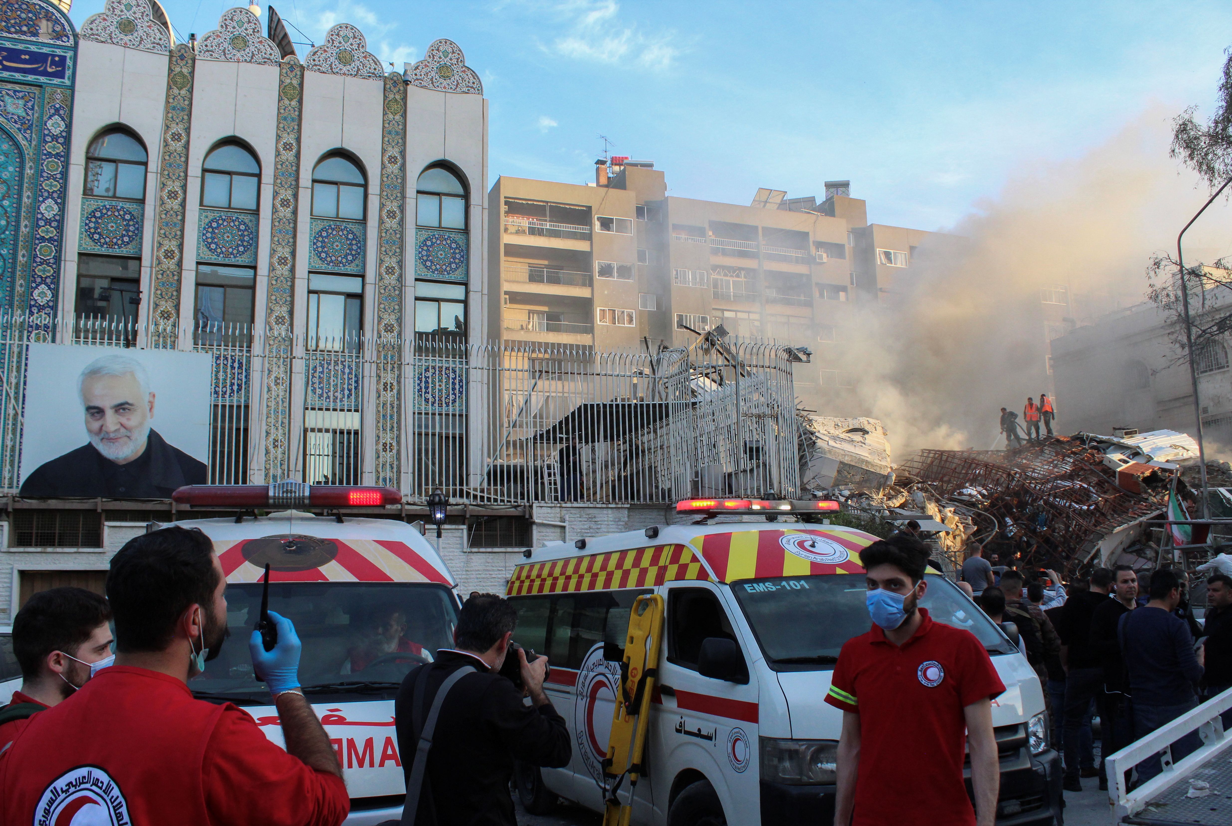 Members of Syrian Red Crescent work near the damaged site after what Syrian and Iranian media described as an Israeli air strike on Iran's consulate in the Syrian capital Damascus April 1, 2024.