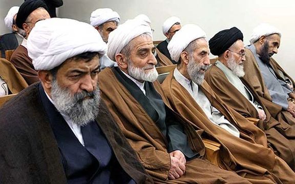A group of older clerics bored during an official ceremony. FILE