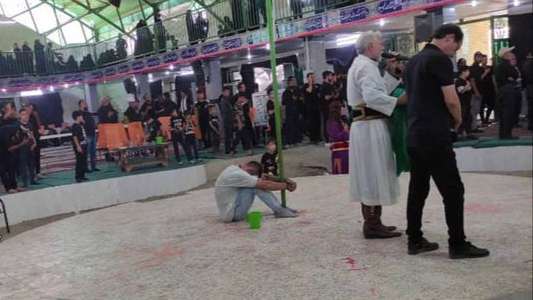 An Iranian mourner tied their own hands and feet to a flagpole to commemorate the death of Khodanour Lojei, a young man shot to death on October 1 in Zahedan, capital of southeastern province of Sistan and Baluchestan.