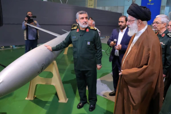 An undated photo showing Khamenei inspecting military hardware.