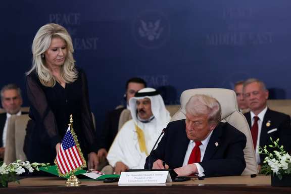US President Donald Trump signs the agreement at a world leaders' summit on ending the Gaza war, in Sharm el-Sheikh, Egypt, October 13, 2025