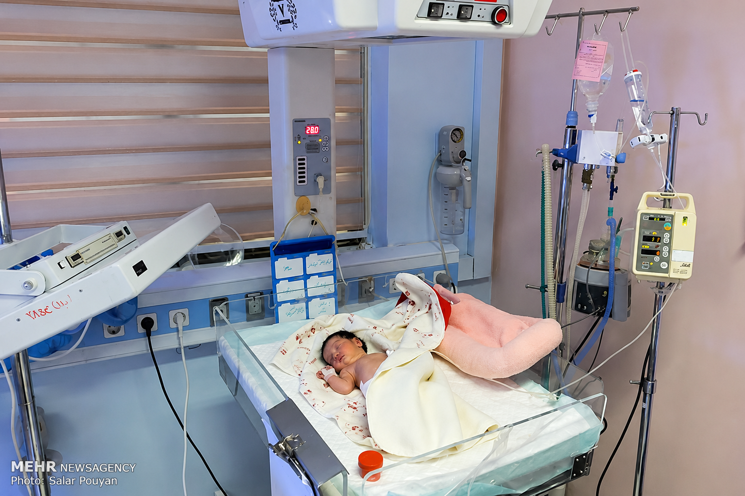A newborn baby rests in a hospital neonatal care unit in Iran. (undated)
