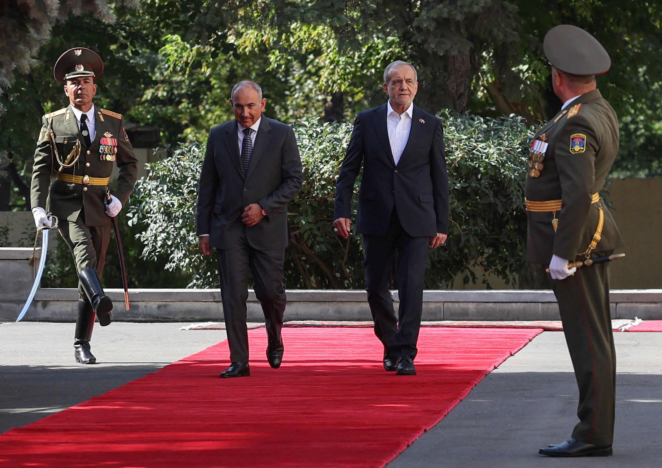Armenian Prime Minister Nikol Pashinyan and Iranian President Masoud Pezeshkian take part in a welcoming ceremony before their talks in Yerevan, Armenia, August 19, 2025.