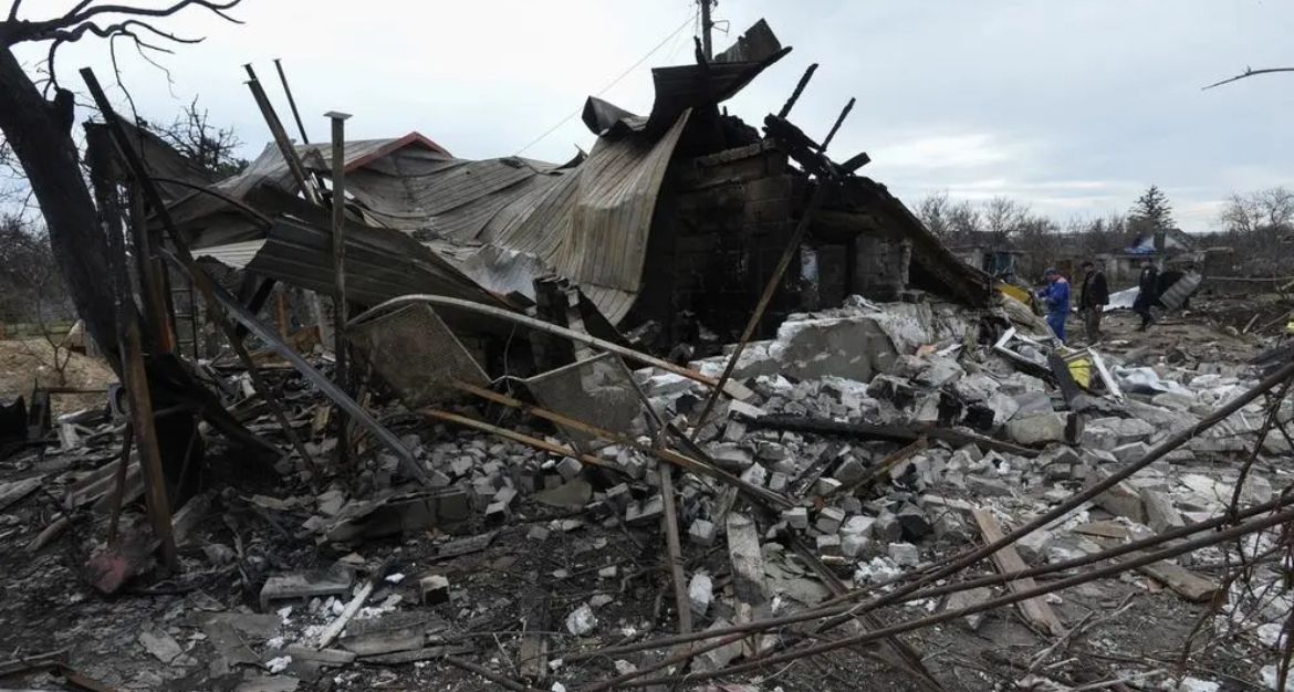 Municipal workers and a police officer inspect remains of a residential building destroyed during a Russian missile and drone strike, amid Russia's attack on Ukraine, in the city of Kamianske, Dnipropetrovsk region, Ukraine March 29, 2024.