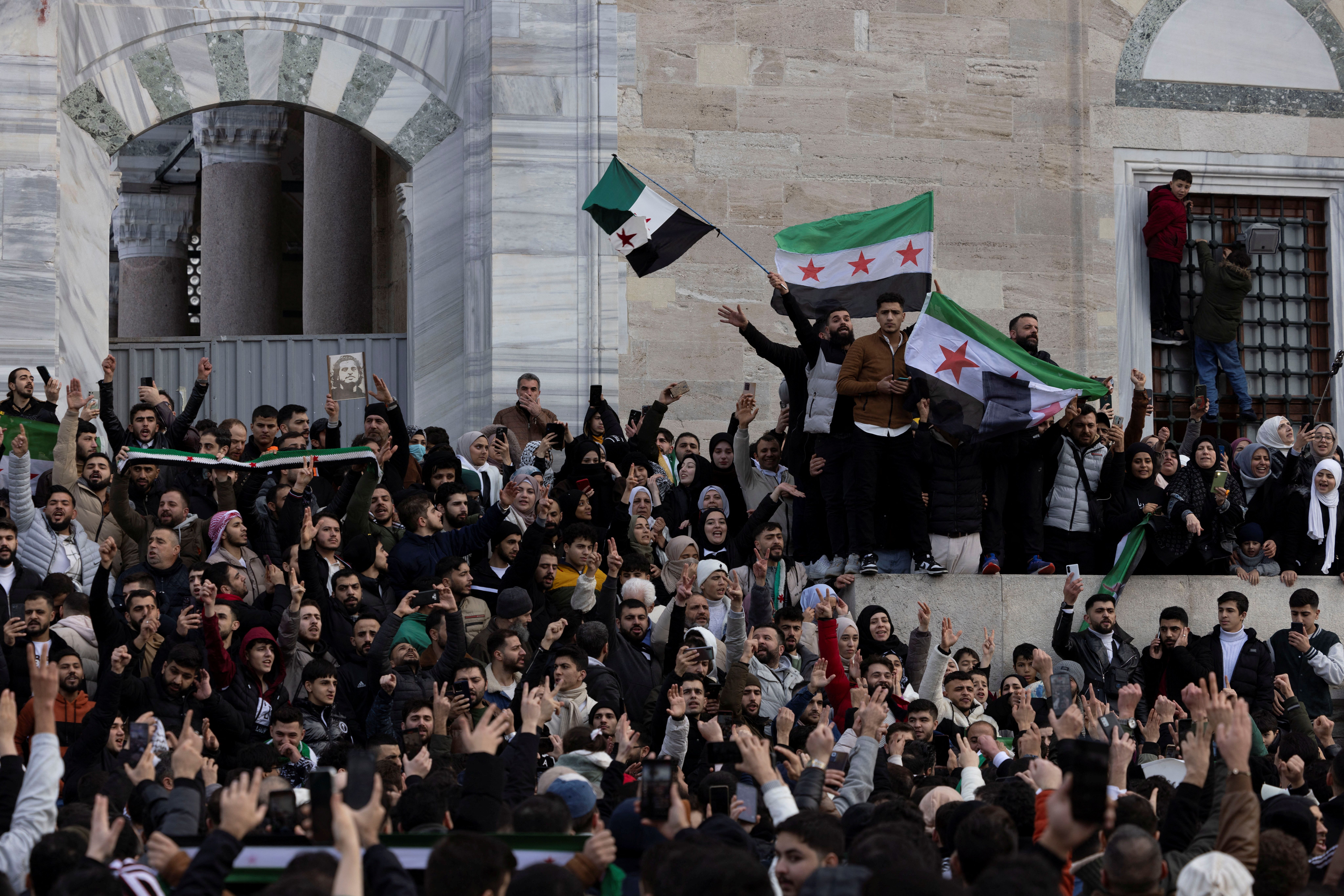 Syrians living in Turkey celebrate with opposition flags after Syrian rebels announced that they have ousted President Bashar al-Assad, in front of the Fatih Mosque in Istanbul, Turkey, December 8, 2024.