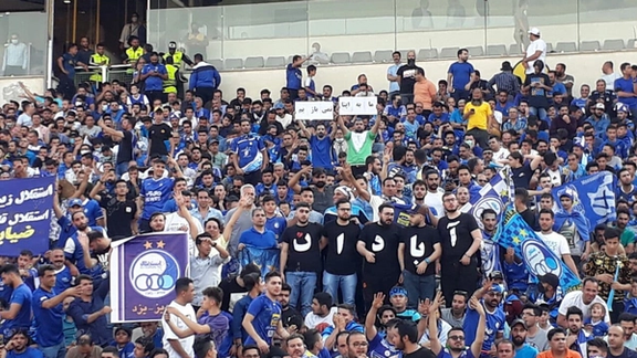 People in Tehran's main soccer stadium unfurl a banner supporting protesters. May 30, 2022