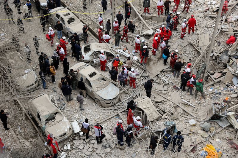 Emergency personnel work at the site of a US-Israeli strike, in Tehran, Iran, March 16, 2026