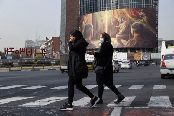 Iranians walk next to a pro-Hezbollah billboard on a street in Tehran, Iran December 8, 2024.