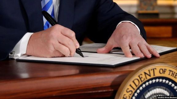 Trump signing the US withdrawal from the JCPOA nuclear deal in May 2018