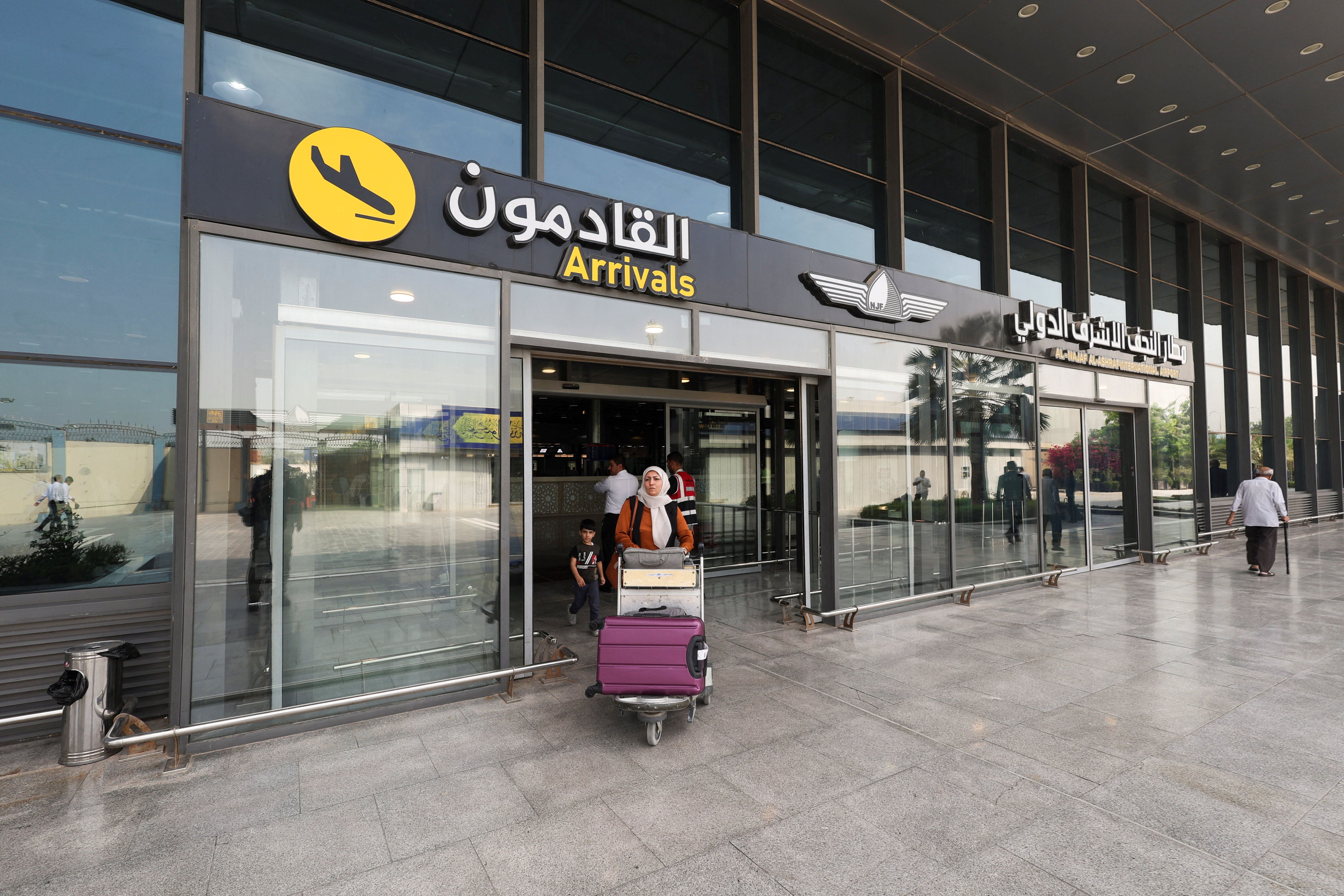 An Iranian passenger carrying luggage leaves Najaf International Airport after arriving on an AVA Airlines flight, in Najaf, Iraq, September 23, 2026.