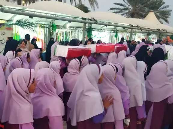 Iranian schoolgirls carrying symbolic coffins in a regime-sponsored propaganda event (January 2024)