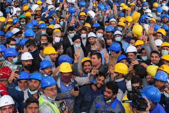 A group of Iranian workers surrounding President Ebrahim Raisi