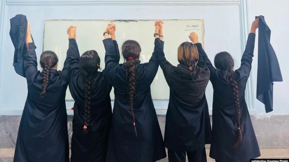 A number of schoolgirls removing their headscarves in support of the protests