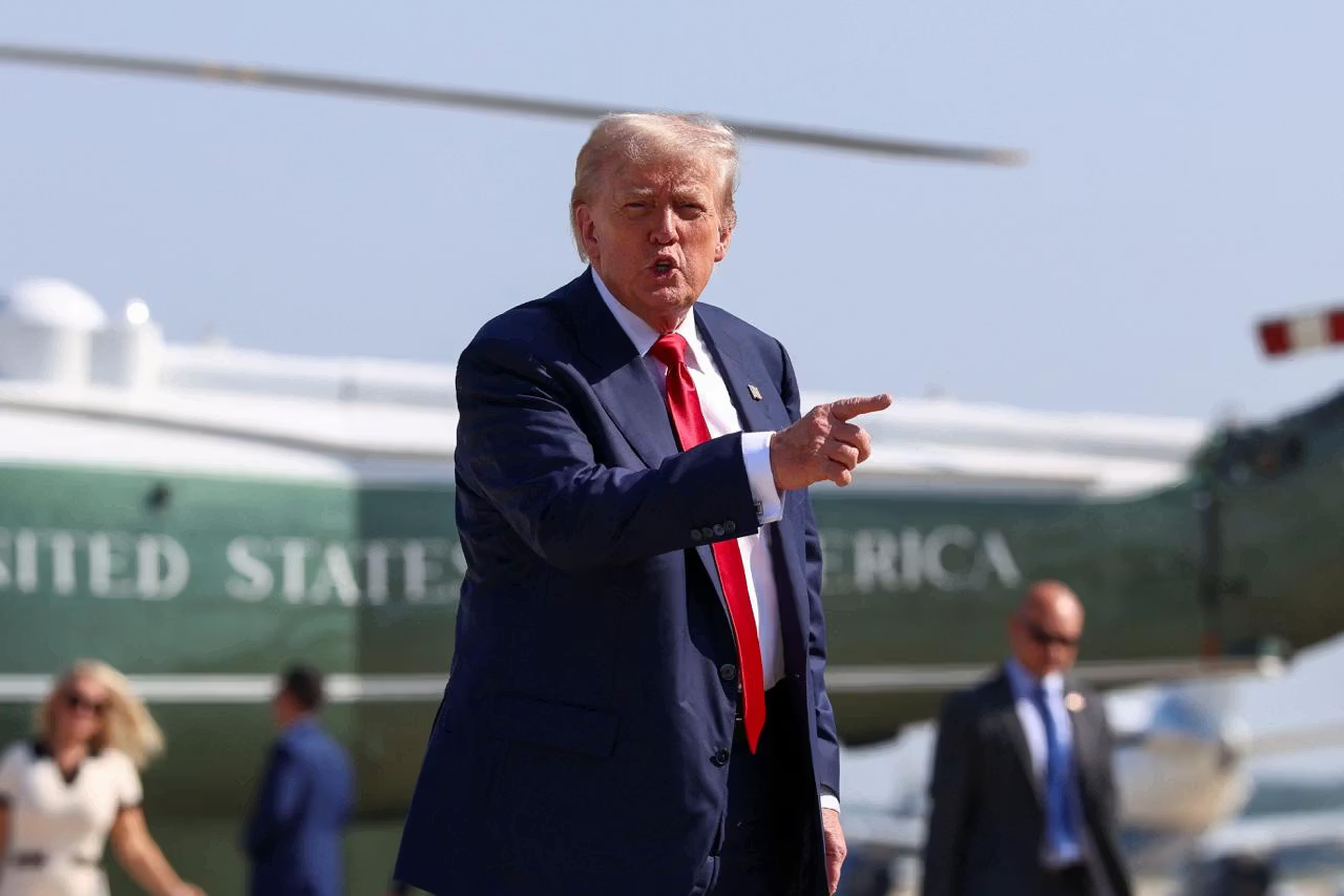 President Donald Trump gestures after disembarking Marine One, as he departs for Scotland, at Joint Base Andrews, Maryland, on July 25, 2025.