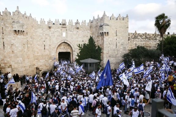 Israelis sing and dance with flags by Damascus gate to Jerusalem's Old city as they mark Jerusalem Day, in Jerusalem May 18, 2023.