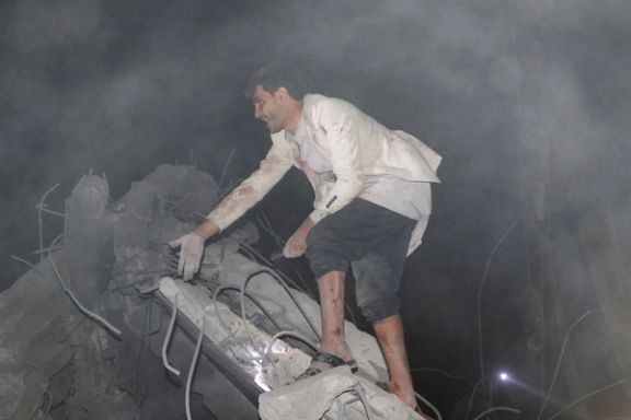 A man gestures as he searches in the rubble of a house hit by a US strike in Saada, Yemen