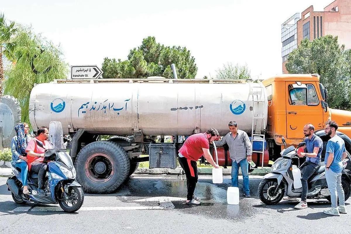 A water tanker distributes clean water in containers to residents on a Tehran street.