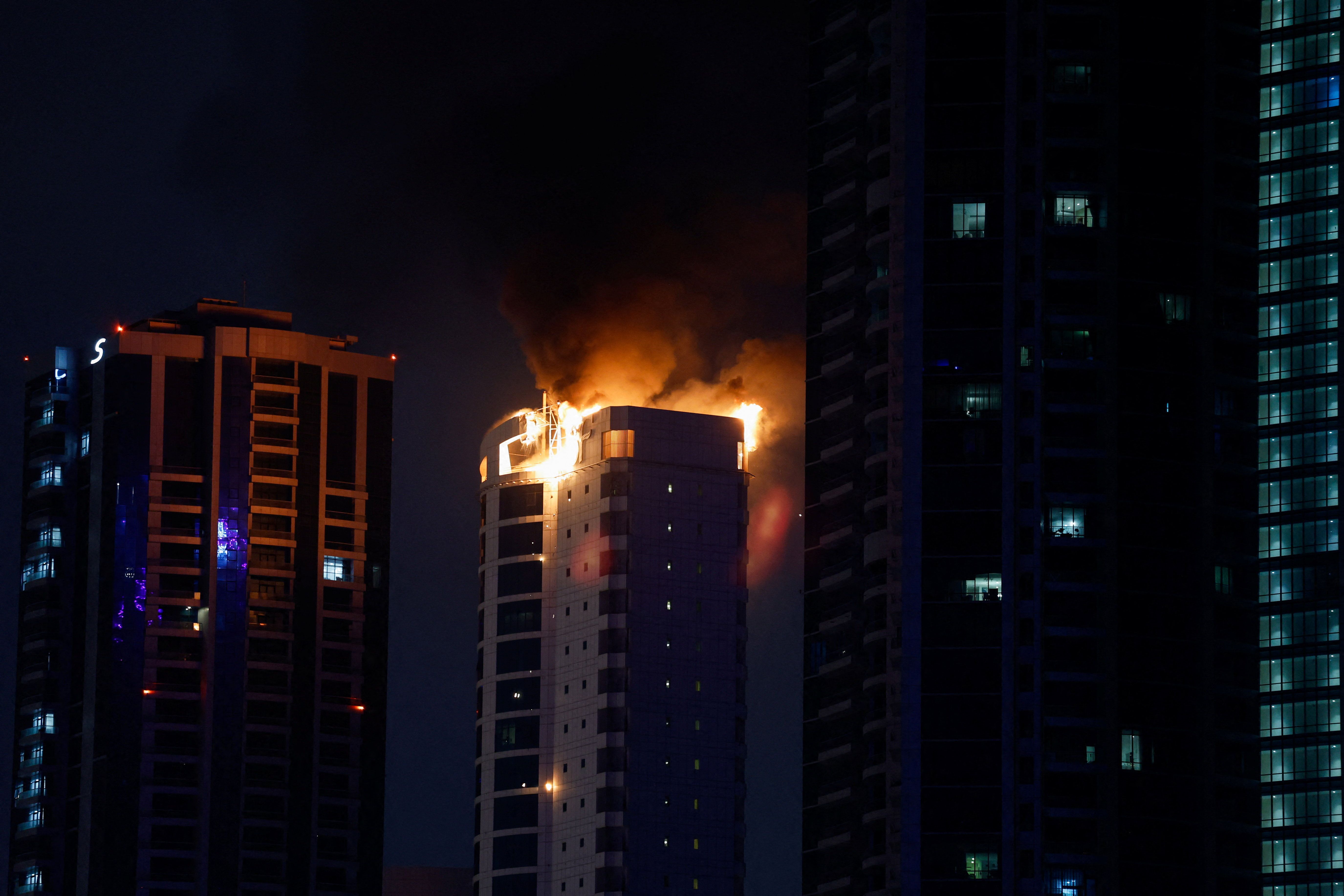 Smoke rises from a burning building hit by an Iranian drone strike in Seef district, Manama, Bahrain, February 28, 2026. 