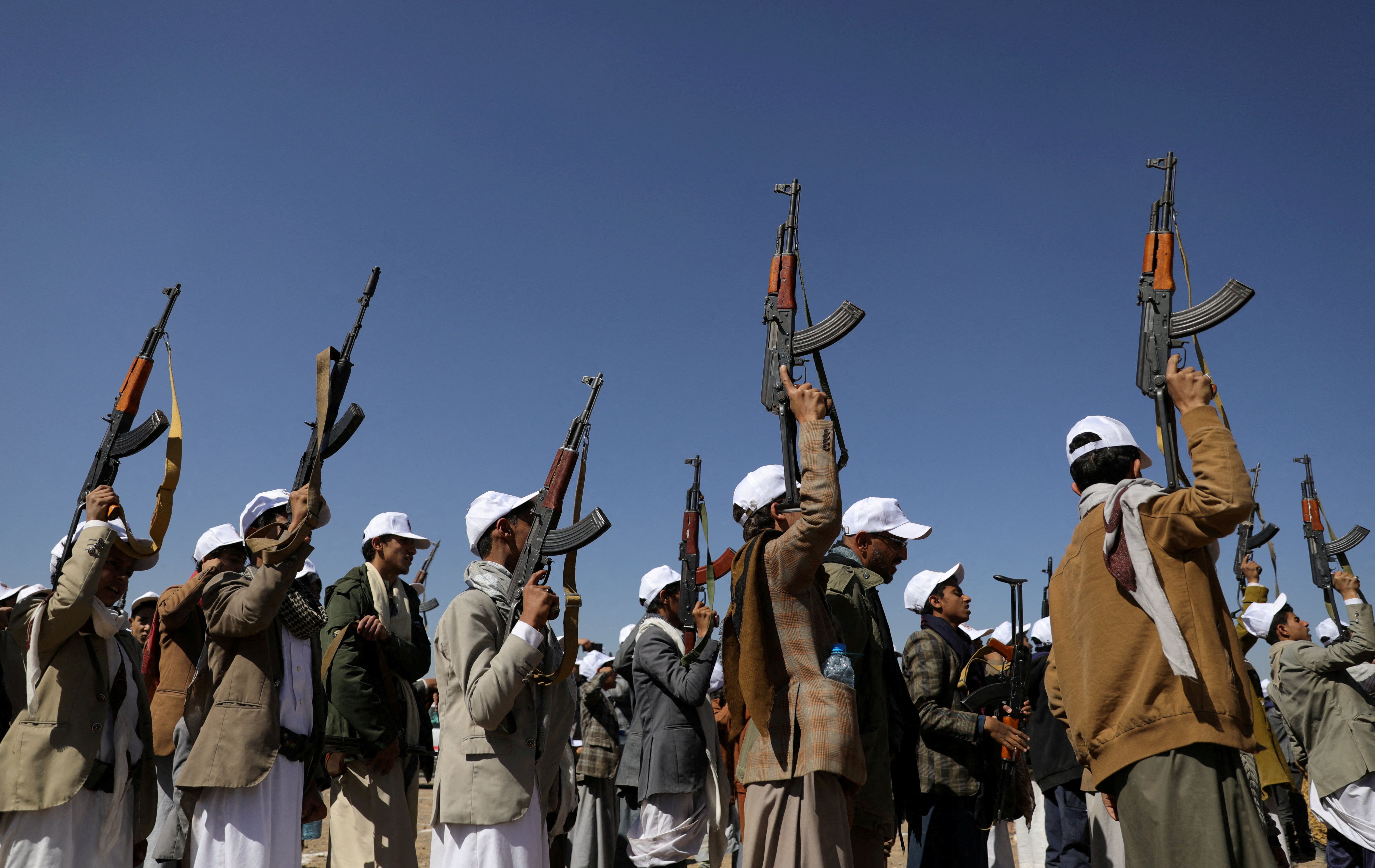 Armed Houthi followers hold up rifles as they take part in a parade to decry the US-led strikes on Houthi targets amid the ongoing conflict between Israel and the Palestinian Islamist group Hamas, near Sana'a, Yemen January 25, 2024. 