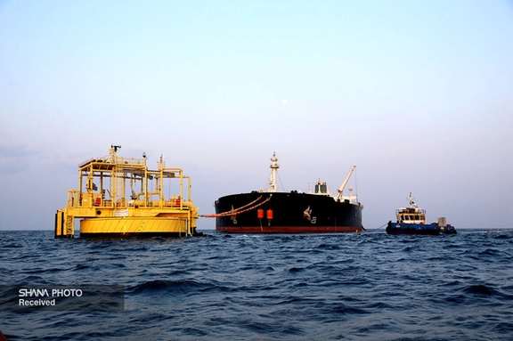 Iranian platform in the Persian gulf loading oil into a tanker in March 2022