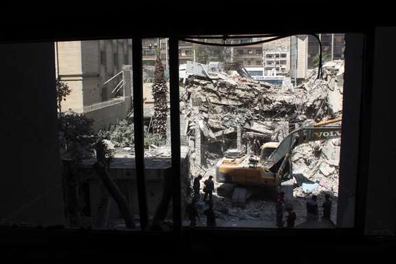An excavator clears rubble after an Israeli strike on Iran's consulate, adjacent to the main Iranian embassy building, in the Syrian capital Damascus, Syria April 2, 2024.