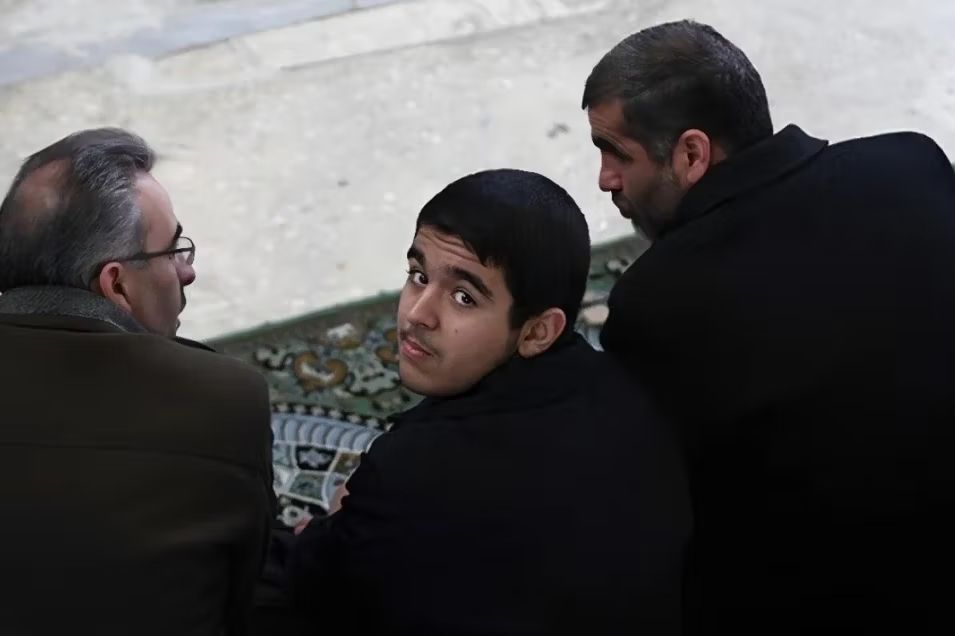 Ali Nikzad and his son at Friday prayers, 2011