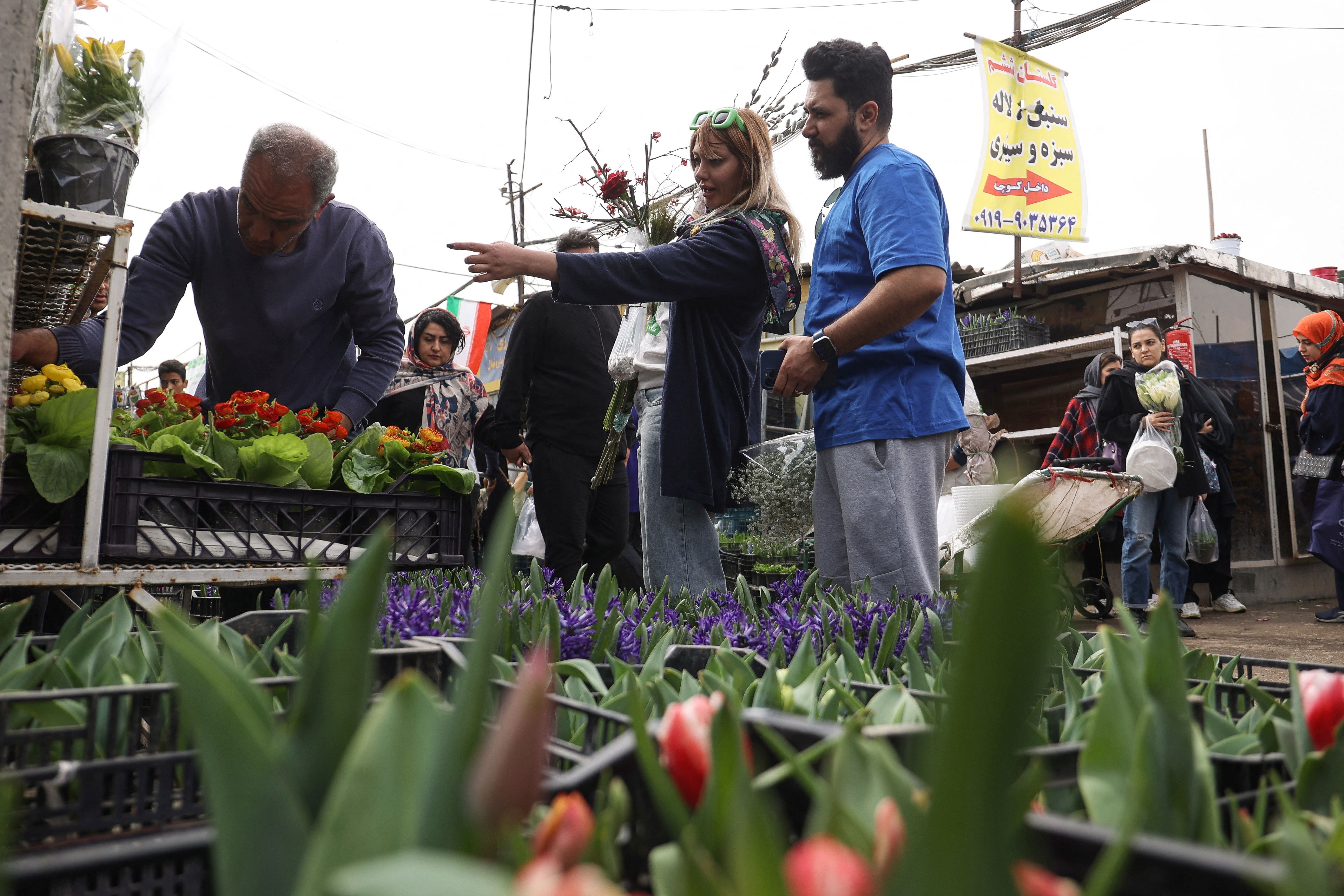 Iranian people shop at a flower market, ahead of Nowruz, the Iranian New Year, in Tehran, Iran March 17, 2024. 