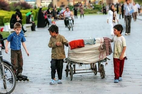 Afghan labor children in Iran, gathered around a cart filled with items, possibly for sale or collection (Undated)