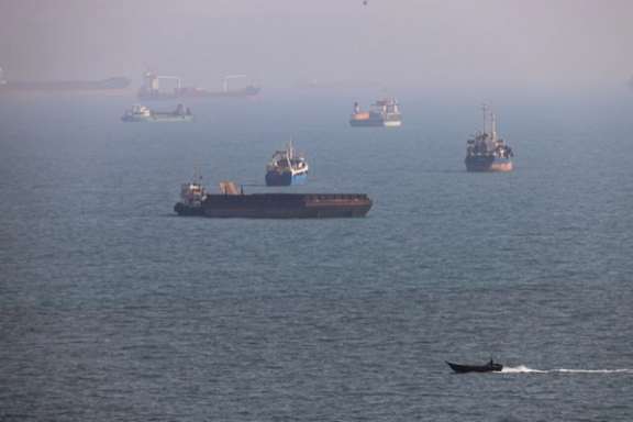 Commercial vessels are seen in waters near the Strait of Hormuz amid ongoing negotiations over shipping arrangements and the reopening of the waterway.